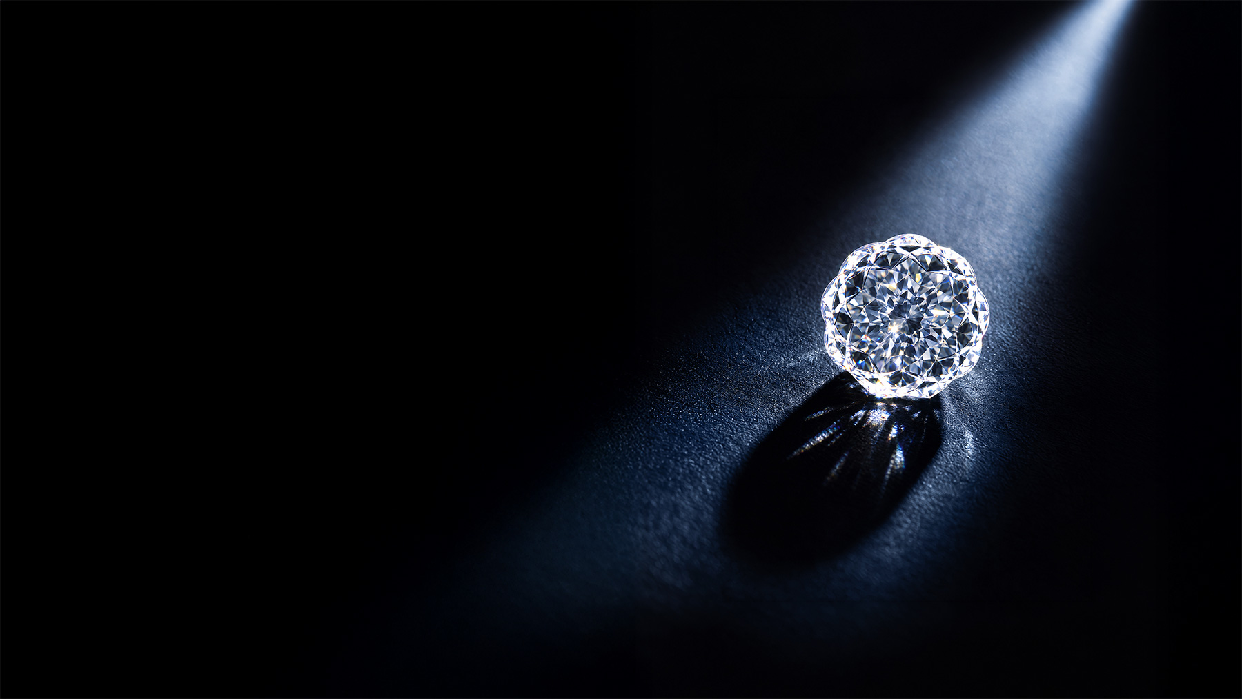 A faceted diamond lit by a single beam of light